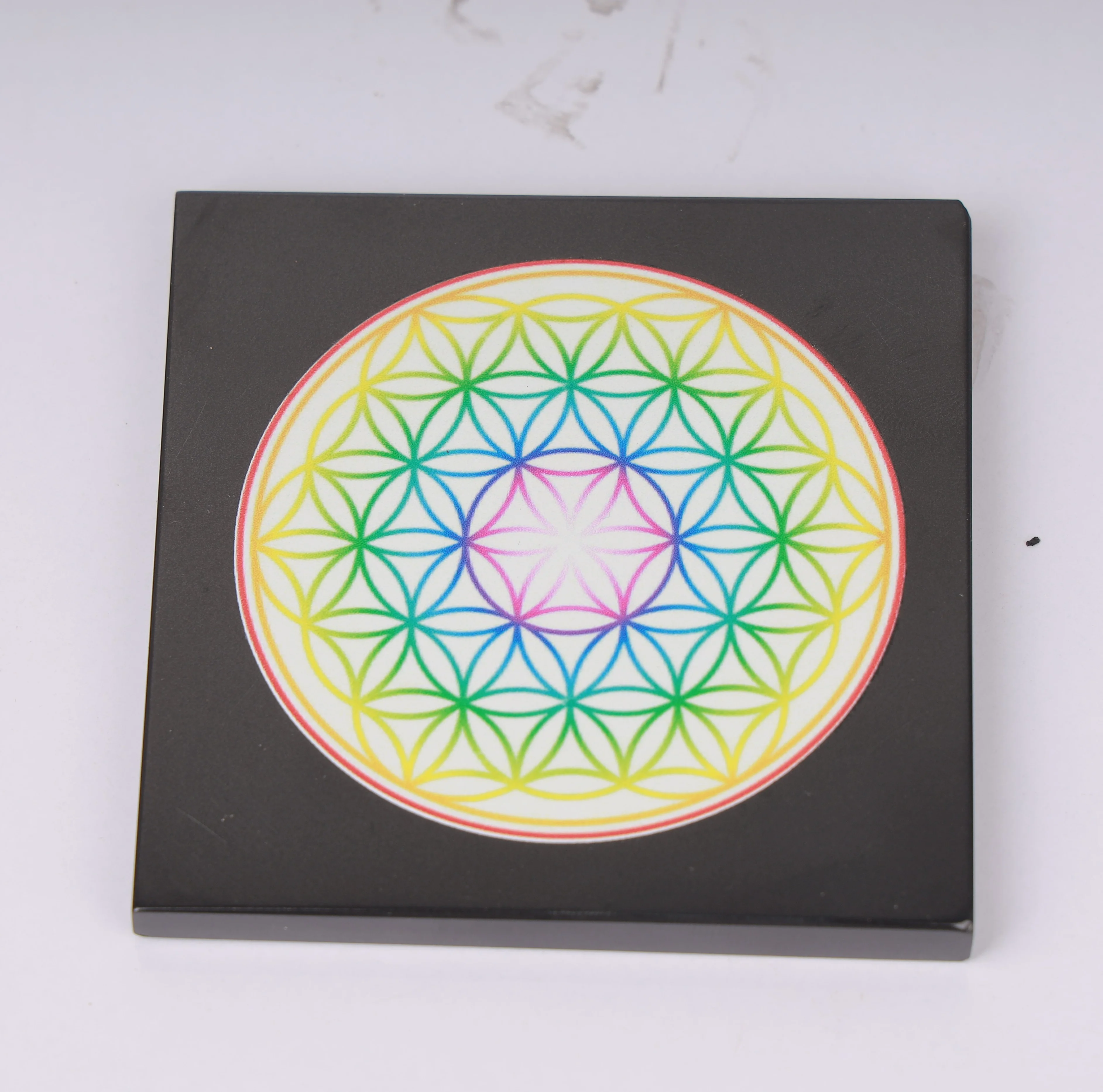 The flower of life sacred geometry in rainbow colors art black agate board